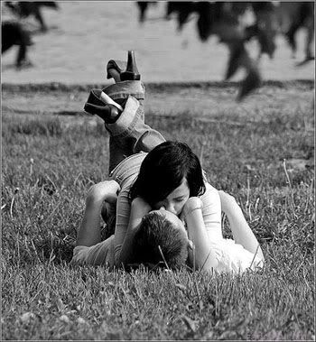 couple kissing in the grass