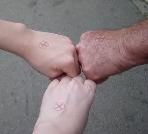 our three hands stamped with an x