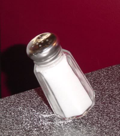 salt shaker balancing on its edge
